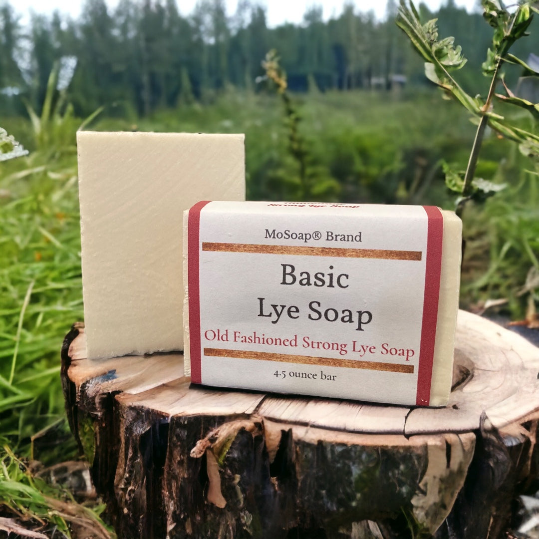 Picture of a wrapped and unwrapped bar of white soap on a tree stump in a grassy field on display
