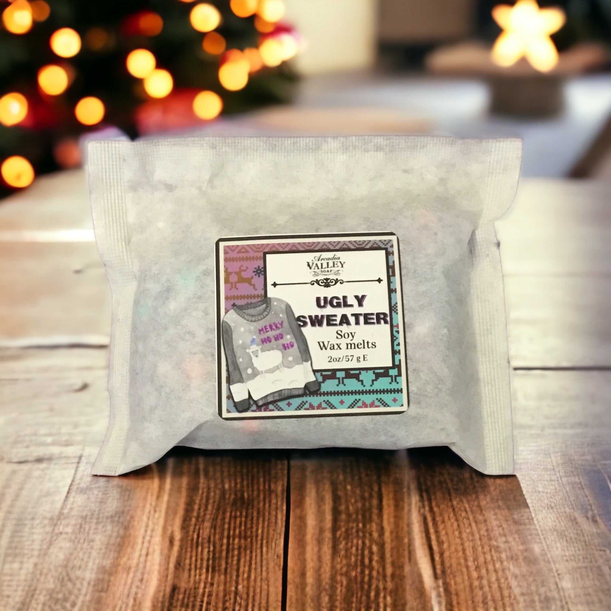 Packed soy wax melts in a white, lightweight paper pouch and with a decorative label on a wooden table with Christmas lights in the background for display