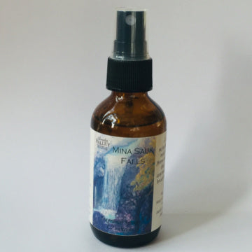 Mina Sauk Fragrance Spray in an amber glass bottle with black plastic mister and decorative label